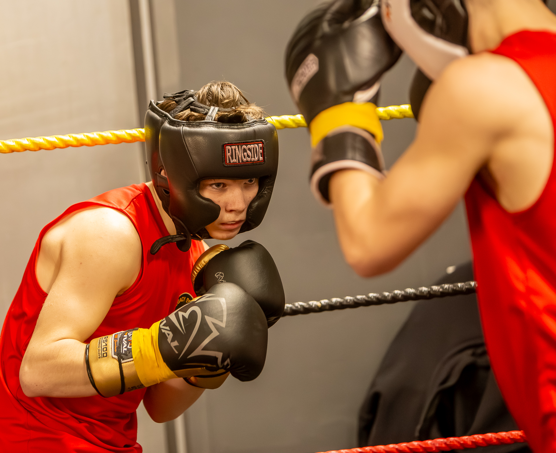 Legacy Boxing athlete training in red headgear