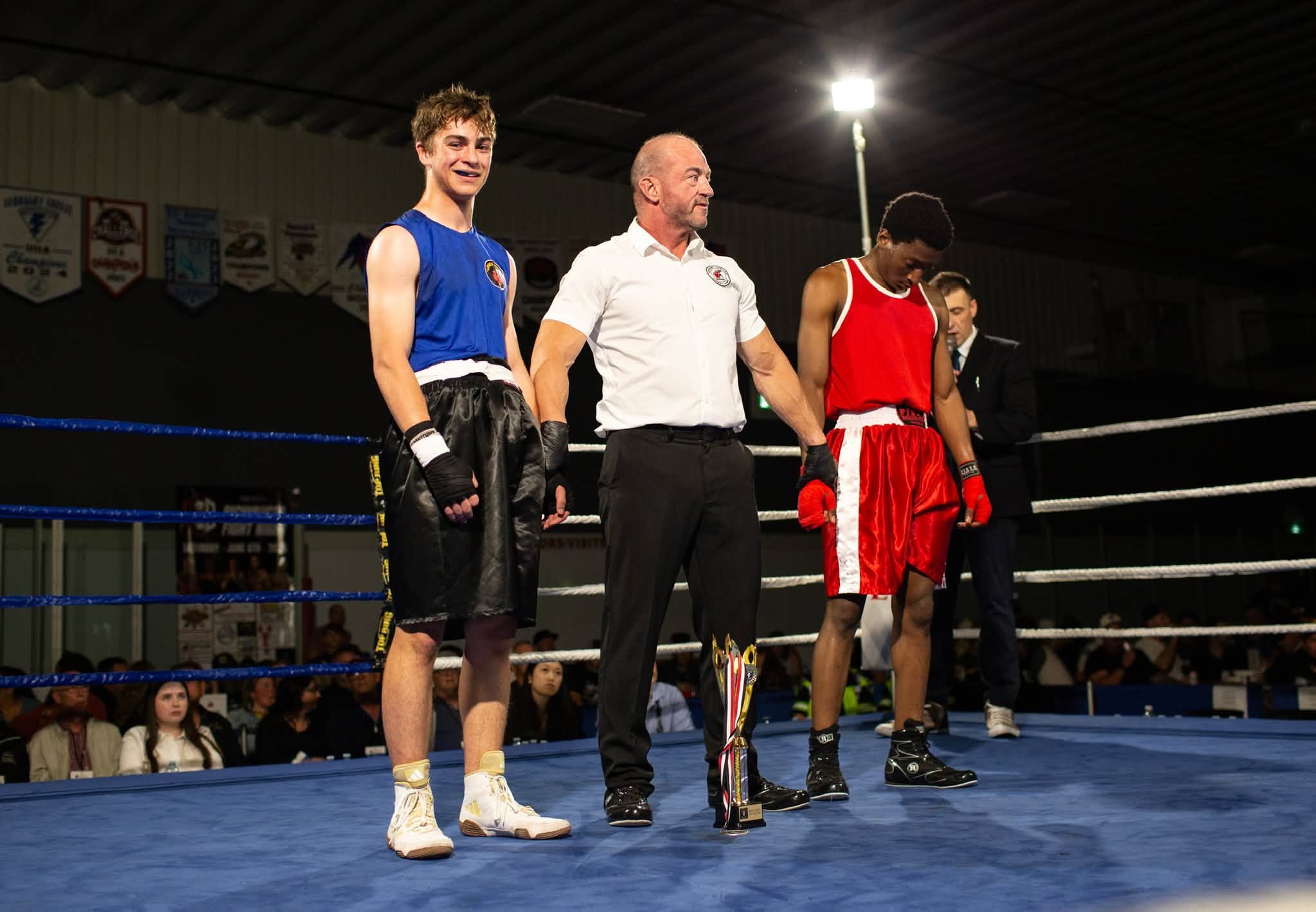 Legacy Boxing athlete with the referee after a ring win